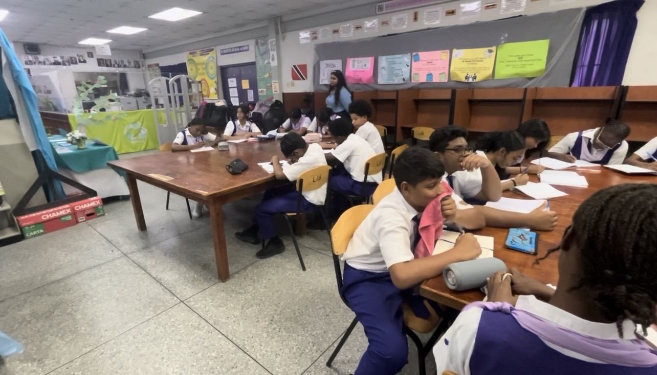 Students working at tables during a lesson