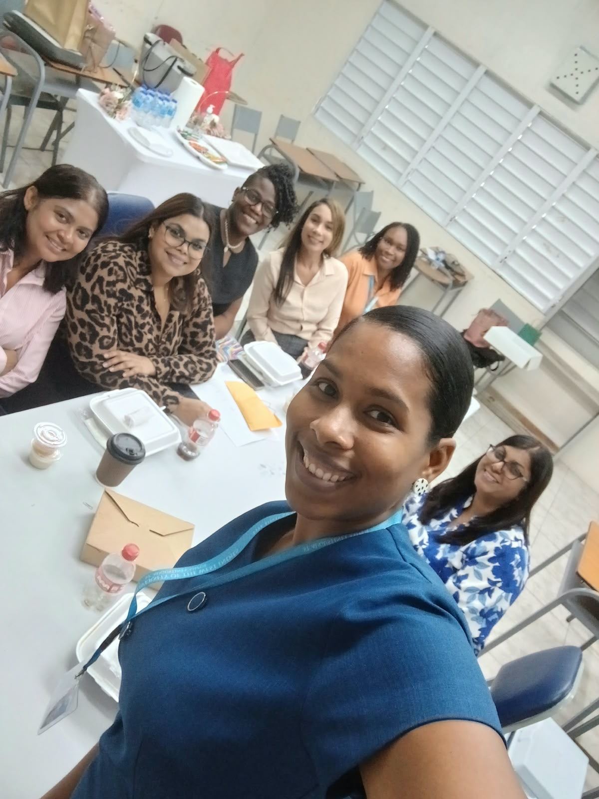 Classmates seated around a table during a session break
